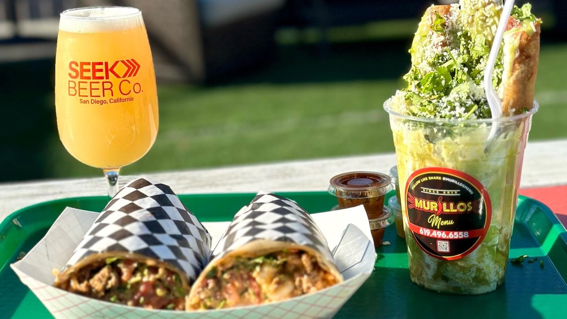 burritos with veggies and a glass of beer